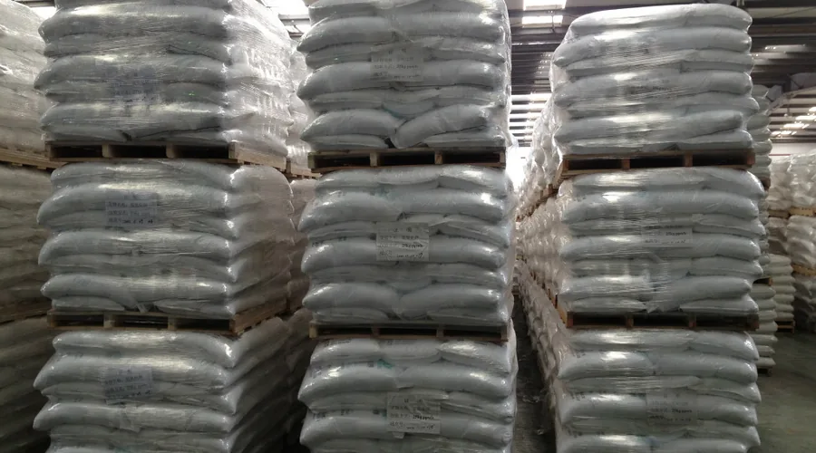Palletized bags of Aluminum Chlorohydrate powder stored in a chemical warehouse